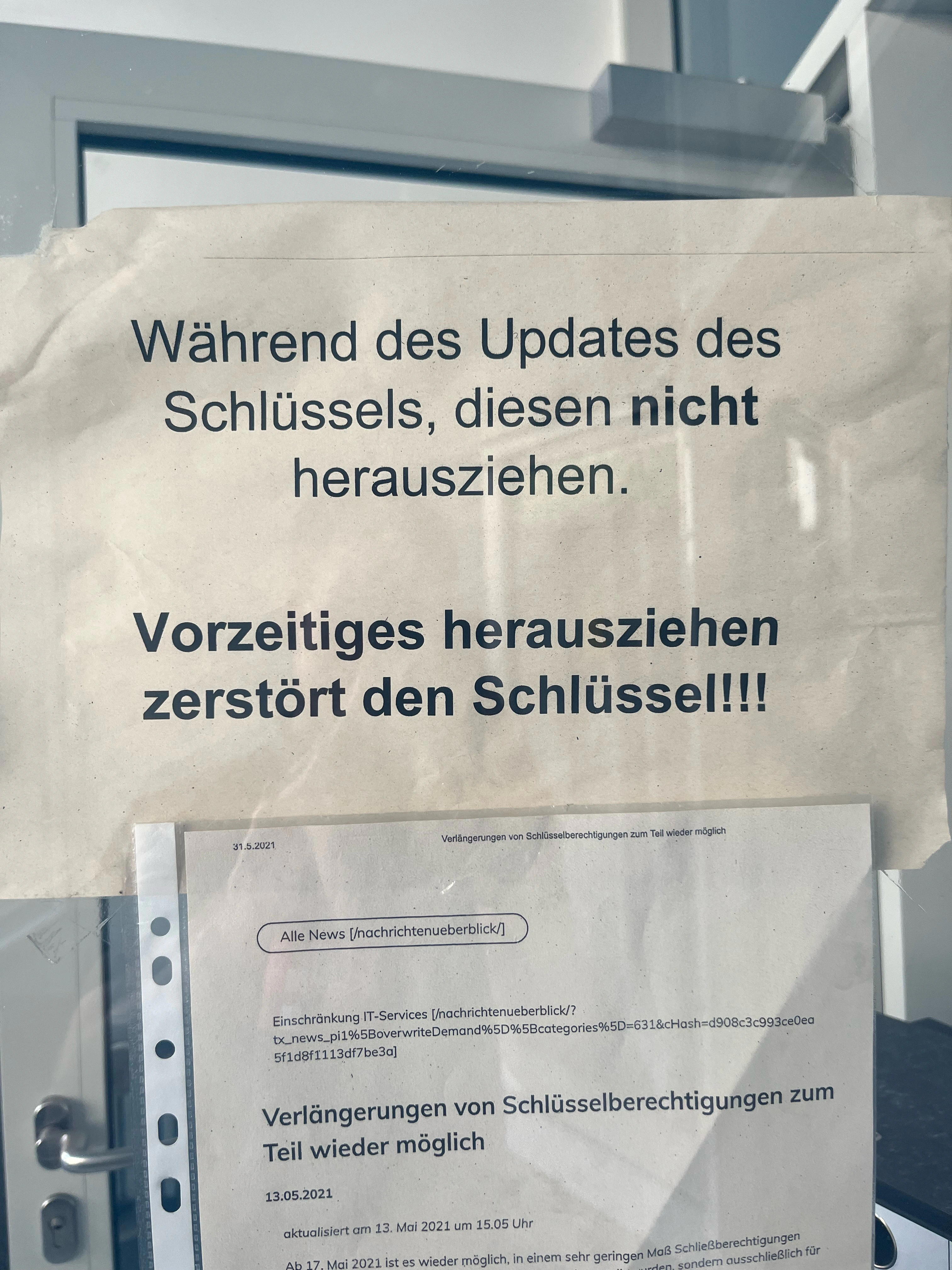 Sign saying: Do not remove key during update. Prematurely removing the key will break it